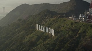 AX0017_093 - 5K aerial stock footage of orbiting the Hollywood Sign in haze, Hollywood, California