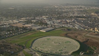 AX0017_114 - 5K aerial stock footage of fly over residential neighborhoods to driving range, Sun Valley, California