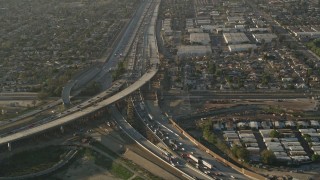 AX0017_116 - 5K aerial stock footage of following interstates with heavy traffic, Sun Valley, California, sunset