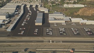 AX0017_118 - 5K aerial stock footage of Whiteman Airport, tilt to parked airplanes, Pacoima, California, sunset