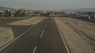 AX0017_120 - 5K aerial stock footage of runway at Whiteman Airport while landing, Pacoima, California, sunset
