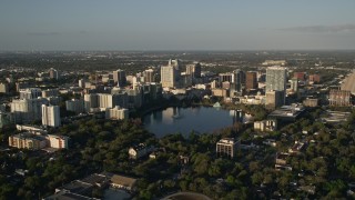 AX0018_001E - 5K aerial stock footage approach Downtown Orlando at sunrise, Florida