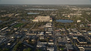 AX0018_008E - 5K aerial stock footage tilt up from neighborhood, reveal Citrus Bowl in Orlando, Florida at Sunrise