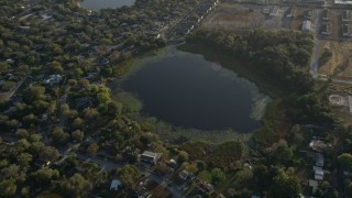 AX0018_023 - 5K aerial stock footage approach Druid Lake in Orlando, Florida at sunrise