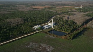 AX0018_032 - 5K aerial stock footage of large water tanks at an Orlando farm at sunrise, Florida