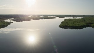AX0018_043E - 5K aerial stock footage fly low altitude over St. Johns River near Orlando at sunrise, Florida