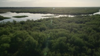 AX0018_048 - 5K aerial stock footage approach and fly over St. Johns River near Orlando at sunrise in Florida
