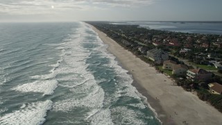 AX0018_069E - 5K aerial stock footage fly over waves on Melbourne Beach in Florida