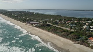 AX0018_071E - 5K aerial stock footage flyby beach motel and homes in Melbourne Beach, Florida