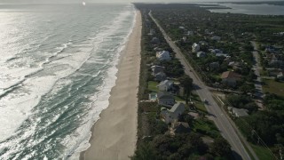 AX0018_081E - 5K aerial stock footage fly over homes on the beach in Melbourne Beach, Florida
