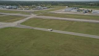 AX0018_101 - 5K aerial stock footage approach small airplane at St. Lucie County International Airport in Florida