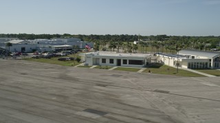 AX0018_102 - 5K aerial stock footage of approaching the office at St. Lucie County International Airport in Florida