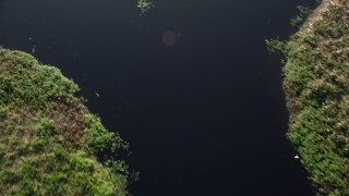 AX0018_103 - 5K aerial stock footage bird's eye view of the water of St. Johns River near Orlando at sunrise in Florida