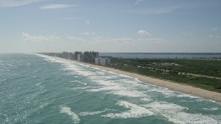 AX0019_007 - 5K aerial stock footage of Jensen Beach apartment buildings by the beach in Florida