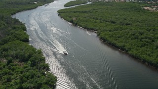 AX0019_012 - 5K aerial stock footage approach and tilt to fishing boat on the Indian River through Hobe Sound, Florida