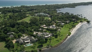 AX0019_020E - 5K aerial stock footage of waterfront mansions in Hobe Sound, Florida