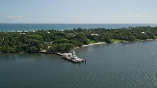 AX0019_023 - 5K aerial stock footage of docked fishing boat on the Indian River by Hobe Sound, Florida