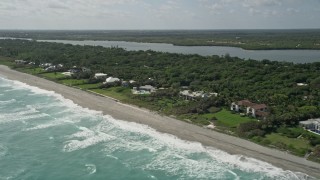 AX0019_026E - 5K aerial stock footage tilt to reveal beachfront mansions in Hobe Sound, Florida