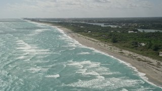 AX0019_030 - 5K aerial stock footage of beach near homes in Hobe Sound, Florida
