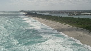 AX0019_032 - 5K aerial stock footage fly over ocean waves by Tequesta Beach in Florida