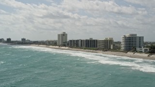 AX0019_034E - 5K aerial stock footage of beachfront apartment buildings in Tequesta, Florida