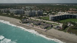 AX0019_040 - 5K aerial stock footage of oceanfront resort on the beach in Jupiter, Florida