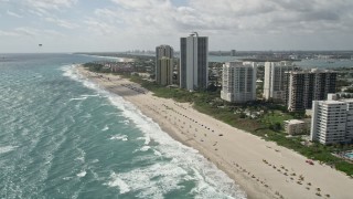 AX0019_048E - 5K aerial stock footage flyby condominium complexes by the beach in Riviera Beach, Florida