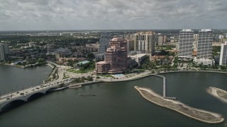 AX0019_061E - 5K aerial stock footage approach lakefront commercial property in West Palm Beach, Florida