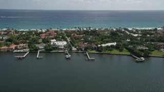 AX0019_066 - 5K aerial stock footage of lakefront mansions with docks in Palm Beach, Florida