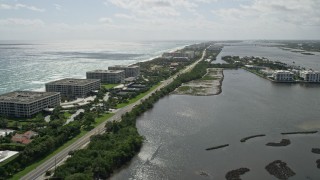 AX0019_071 - 5K aerial stock footage of oceanfront office buildings by a Lakeside Road in Palm Beach, Florida