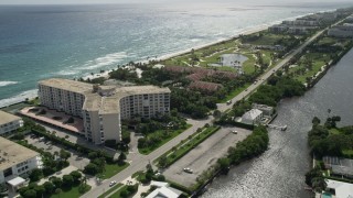 AX0019_072 - 5K aerial stock footage of oceanfront condominiums and golf course in Palm Beach, Florida