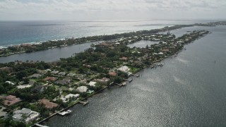 AX0019_078E - 5K aerial stock footage of lakefront mansions with docks on an island in Manalapan, Florida