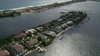 AX0019_080E - 5K aerial stock footage flyby a narrow island with large, waterfront mansions in Manalapan, Florida