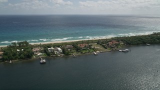 AX0019_082 - 5K aerial stock footage of a row of lakeside mansions with docks in Manalapan, Florida