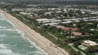 AX0019_086 - 5K aerial stock footage of Ocean Ridge coastal community, tilt to apartment buildings in Florida