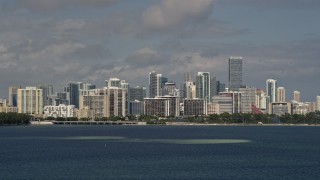 AX0020_010 - 5K stock footage aerial video tilt from the bay to reveal the Downtown Miami skyline in Florida