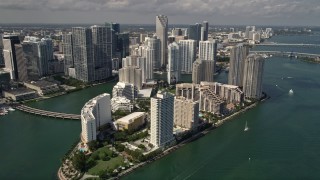 AX0020_024 - 5K aerial stock footage of waterfront hotels and skyscrapers on Brickell Key in the coastal city of Miami, Florida
