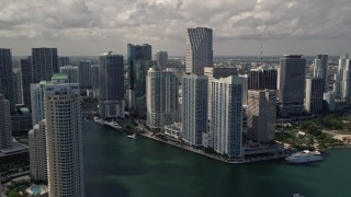 AX0020_025 - 5K stock footage aerial video flyby Brickell Key skyscrapers to reveal Miami River through Downtown Miami, Florida