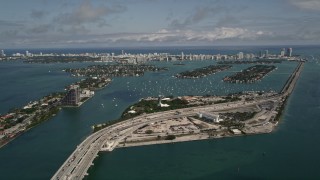 AX0020_031 - 5K aerial stock footage of MacArthur Causeway and Watson Island on the coast in Biscayne Bay, Florida