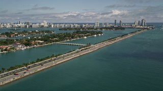 AX0020_035E - 5K aerial stock footage of MacArthur Causeway with light traffic and Palm Island in Miami, Florida