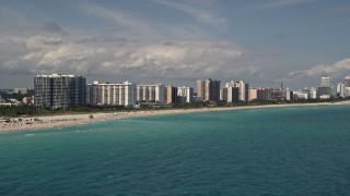 AX0020_049 - 5K aerial stock footage of a row of beachfront condominium complexes in Miami Beach, Florida