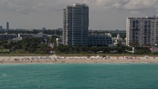 AX0020_050 - 5K stock footage aerial video flyby row of beachfront condominiums in Miami Beach, Florida