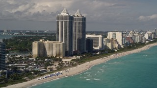 AX0020_054E - 5K aerial stock footage of twin towers of beachfront skyscrapers in Miami Beach, Florida