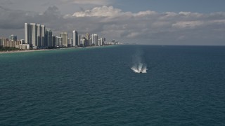 AX0020_072 - 5K aerial stock footage approach a yacht racing across calm ocean near Sunny Isles Beach, Florida