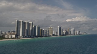 AX0020_073 - 5K aerial stock footage of oceanfront skyscrapers along the coast in Sunny Isles Beach, Florida