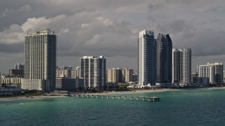 AX0020_075E - 5K aerial stock footage of oceanfront high-rises along the beach in Sunny Isles Beach, Florida