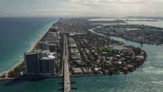 AX0020_091 - 5K aerial stock footage tilt from coastal road to reveal residential neighborhoods in Bal Harbour, Florida