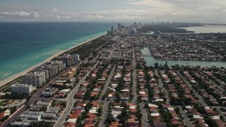 AX0020_095 - 5K aerial stock footage tilt up and fly over coastal residential neighborhoods in Surfside, Florida