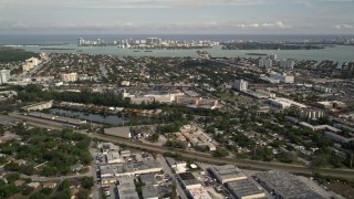AX0021_003E - 5K aerial stock footage of North Miami suburban neighborhood, reveal Bal Harbour, Florida