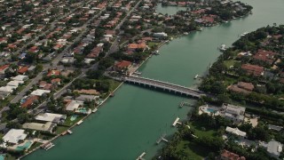 AX0021_016 - 5K aerial stock footage of a bridge connecting Indian Creek Village with Surfside in Florida
